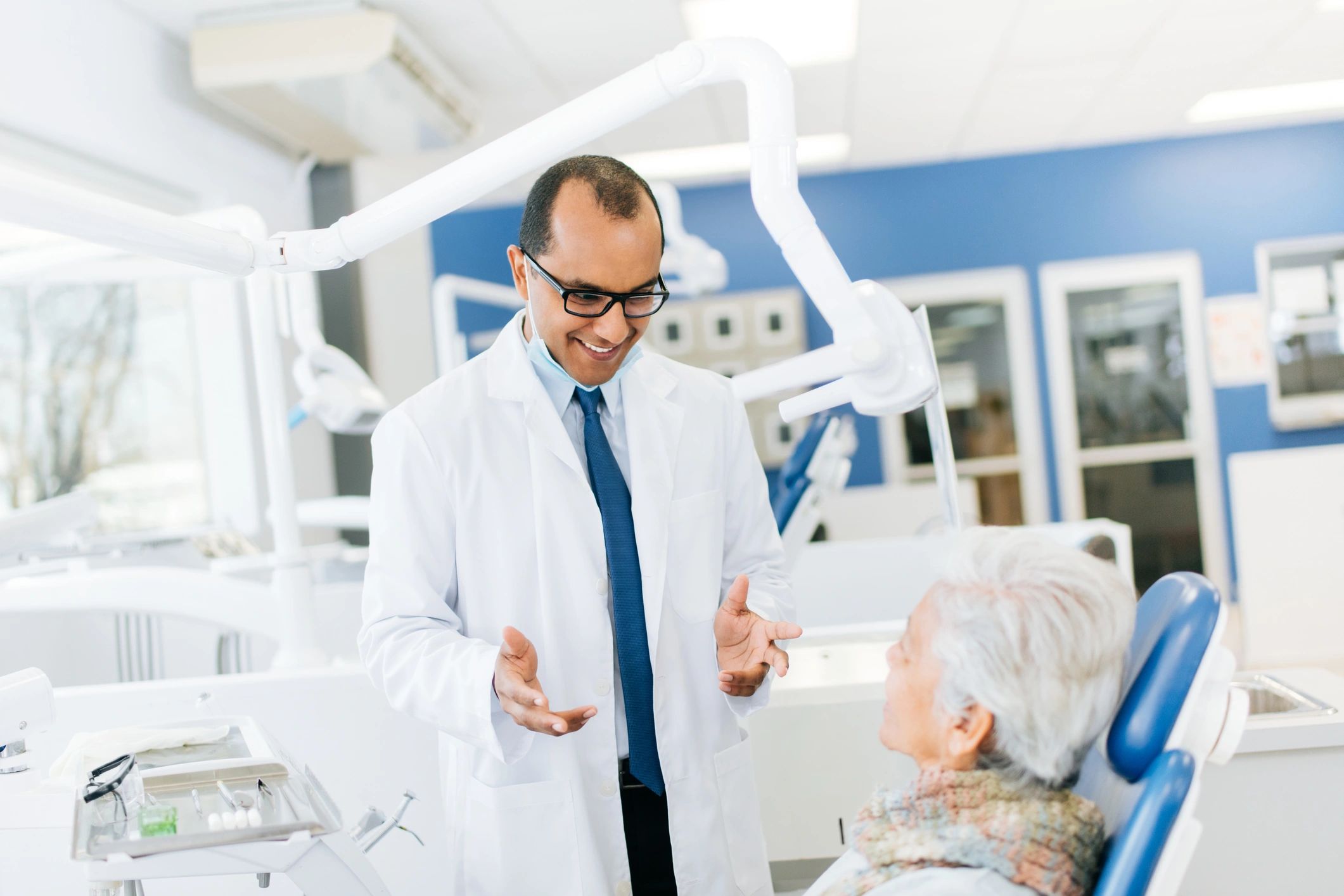 Dentist explaining treatment to a senior female patient