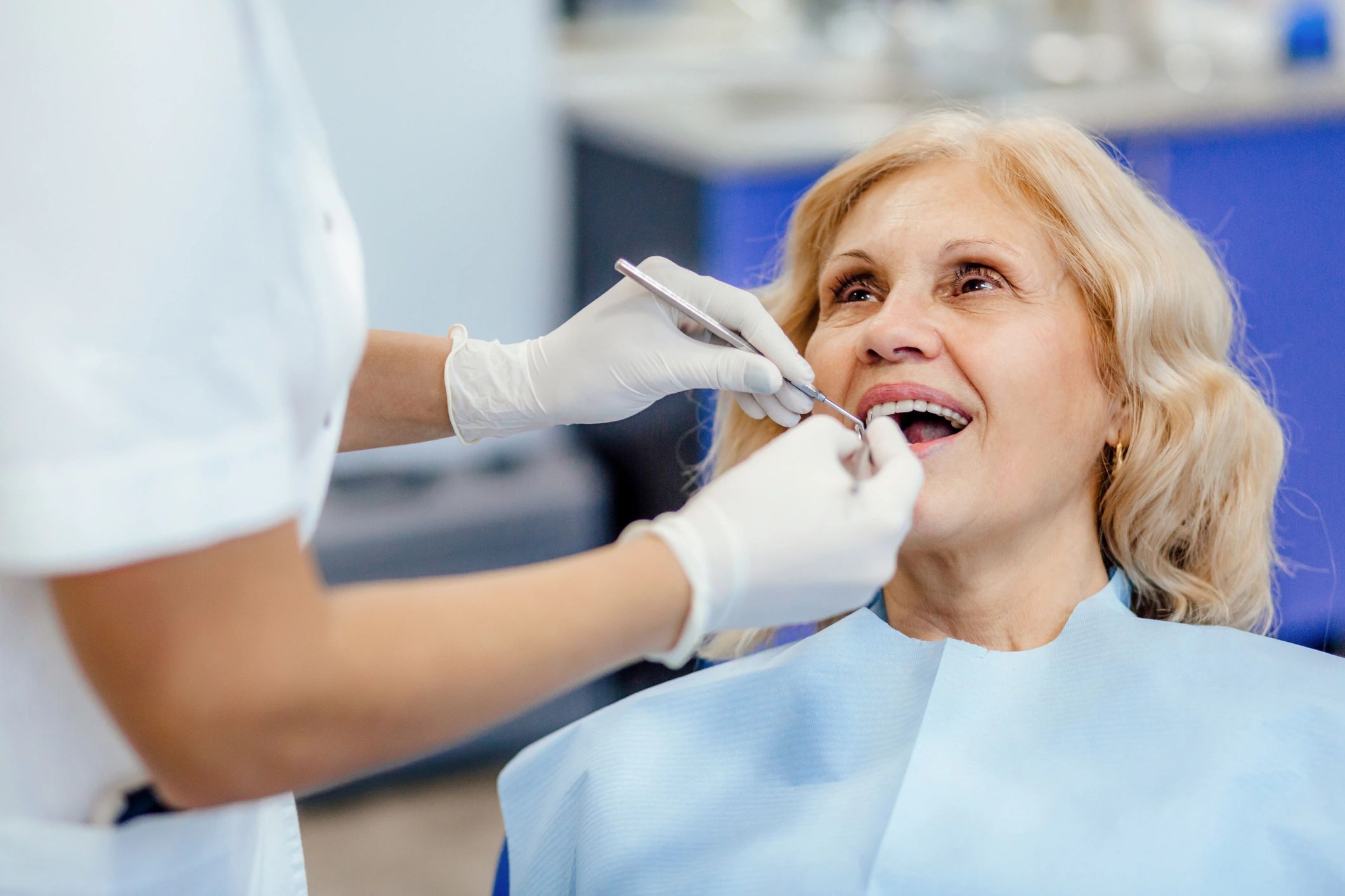 Dentist consulting an elderly patient during a checkup