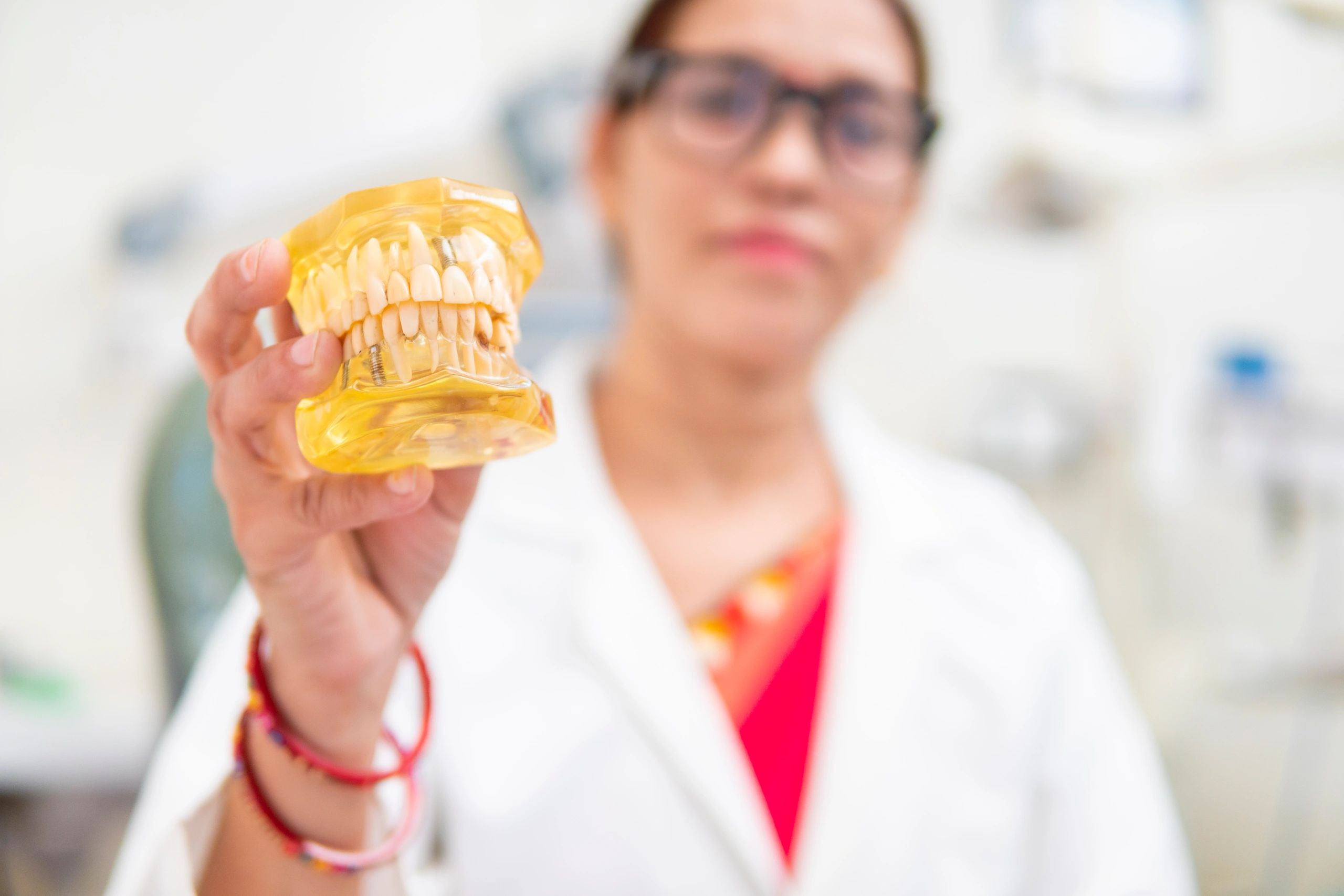 Dentist holding a dental model during aligner consultation