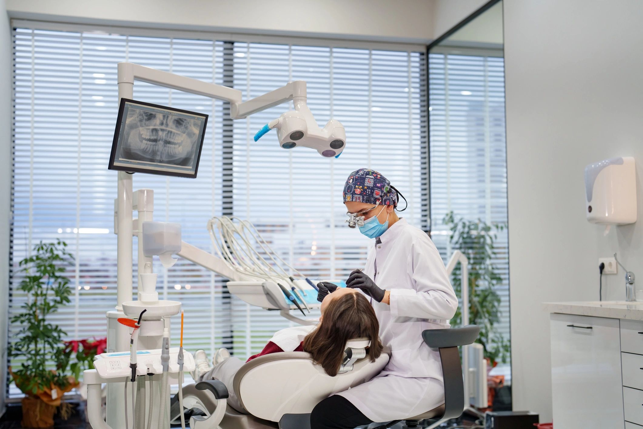 Dentist examining a patient during treatment consultation