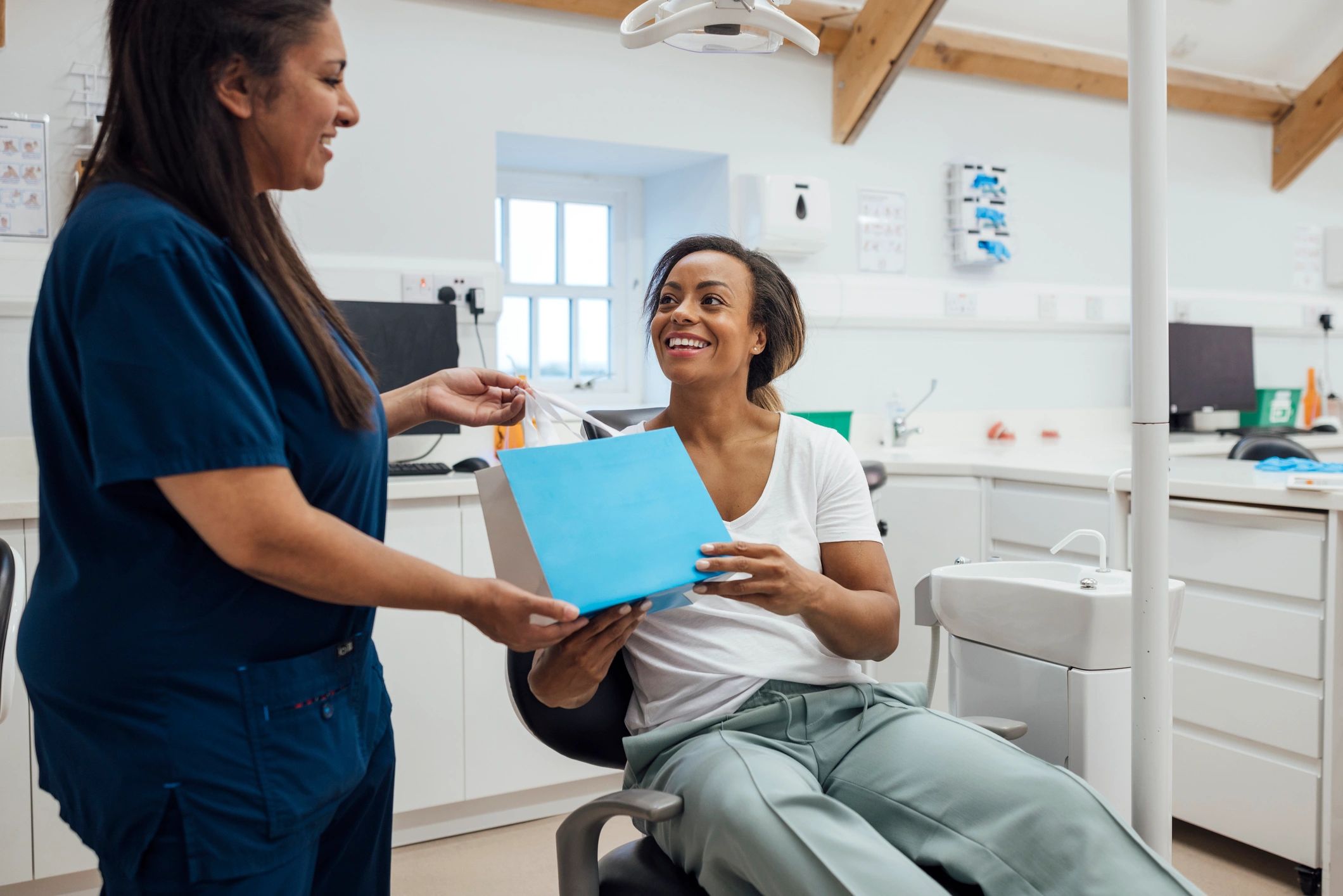 Patient receiving aligner guidance from a dentist during a follow-up appointment