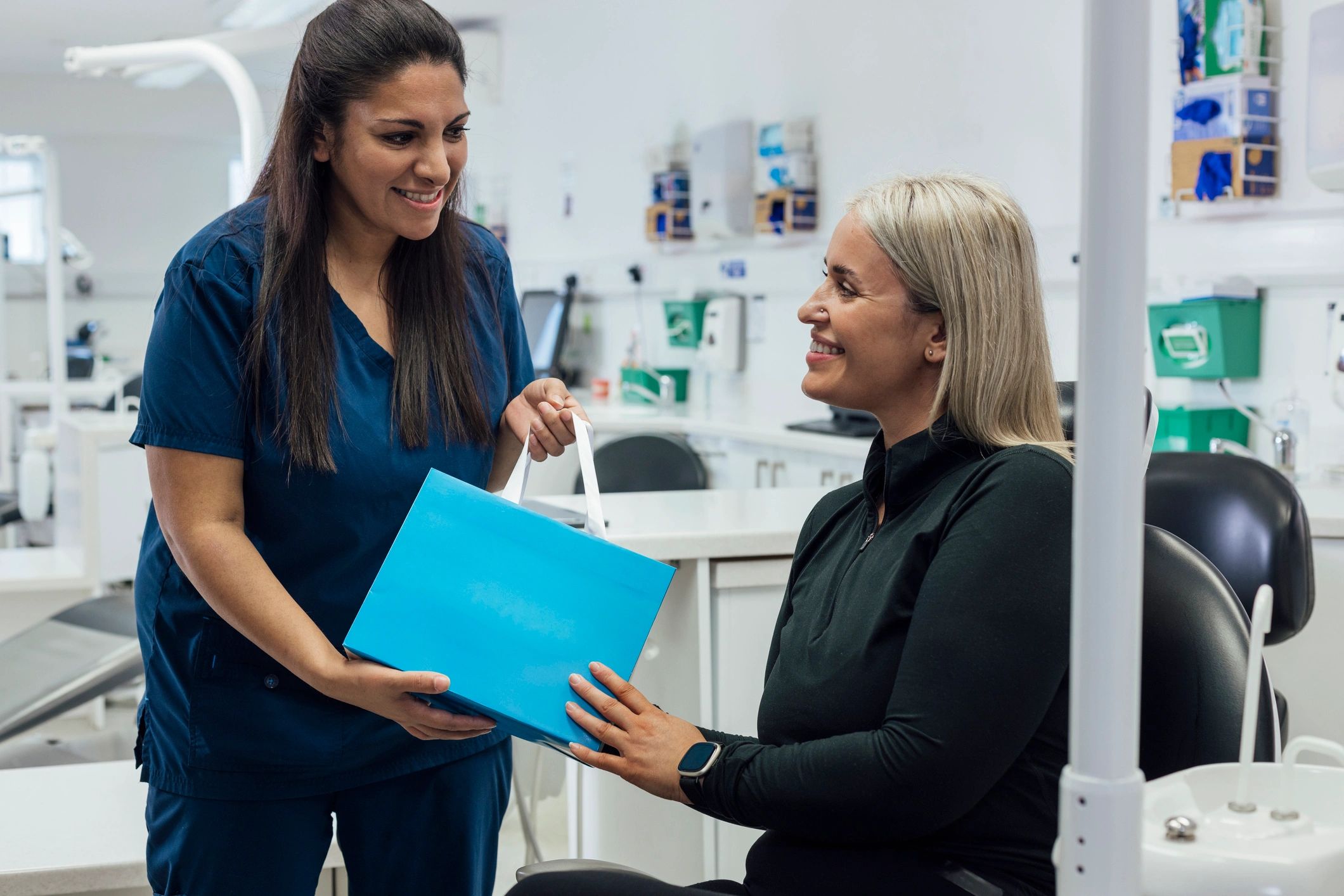 Dentist explaining post-treatment care instructions to a patient