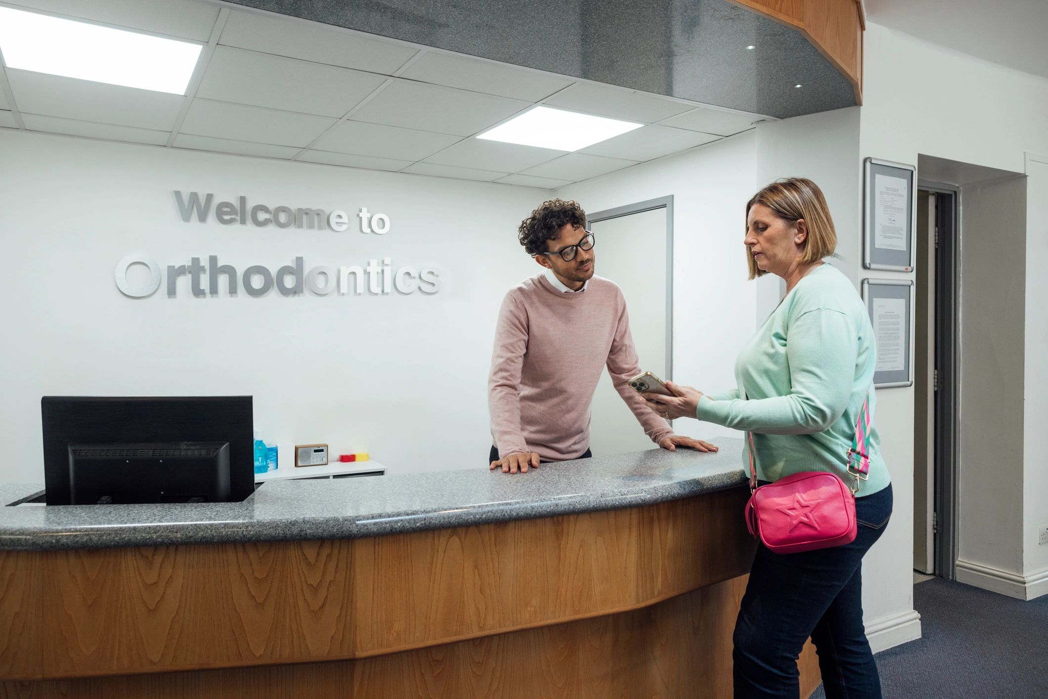 Patient speaking with clinic staff before an appointment