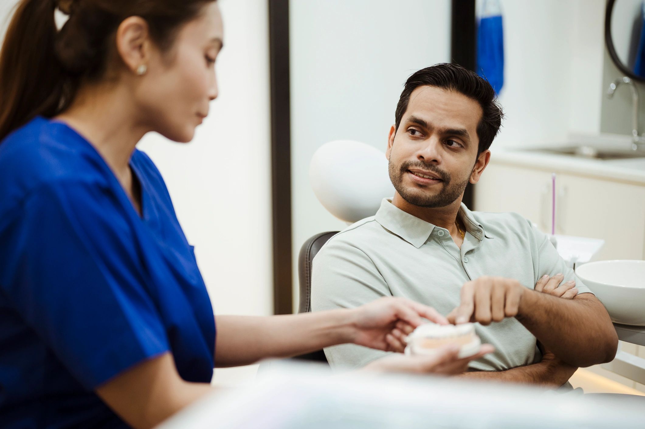Dentist discussing treatment options with patient in modern clinic